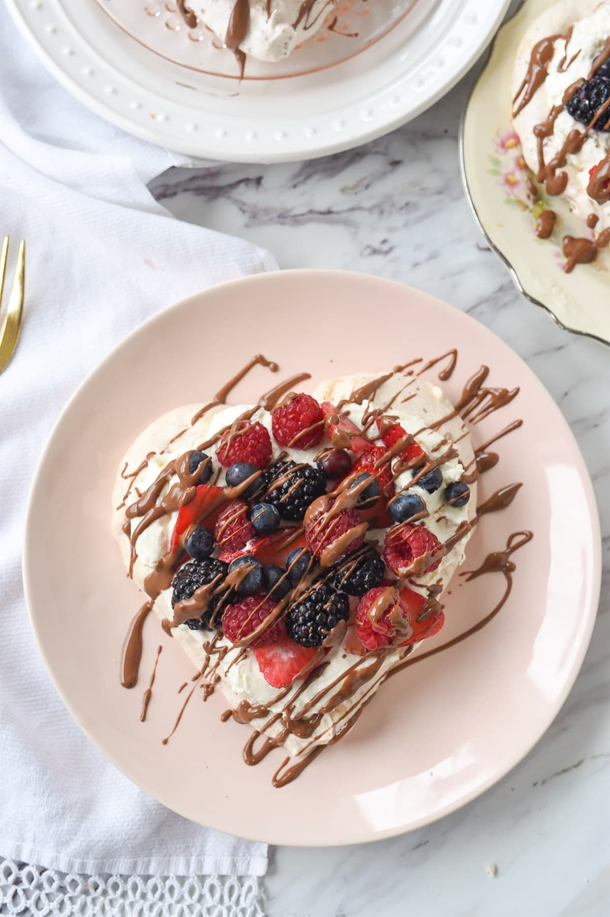 heart shaped pavlova with fruit on it
