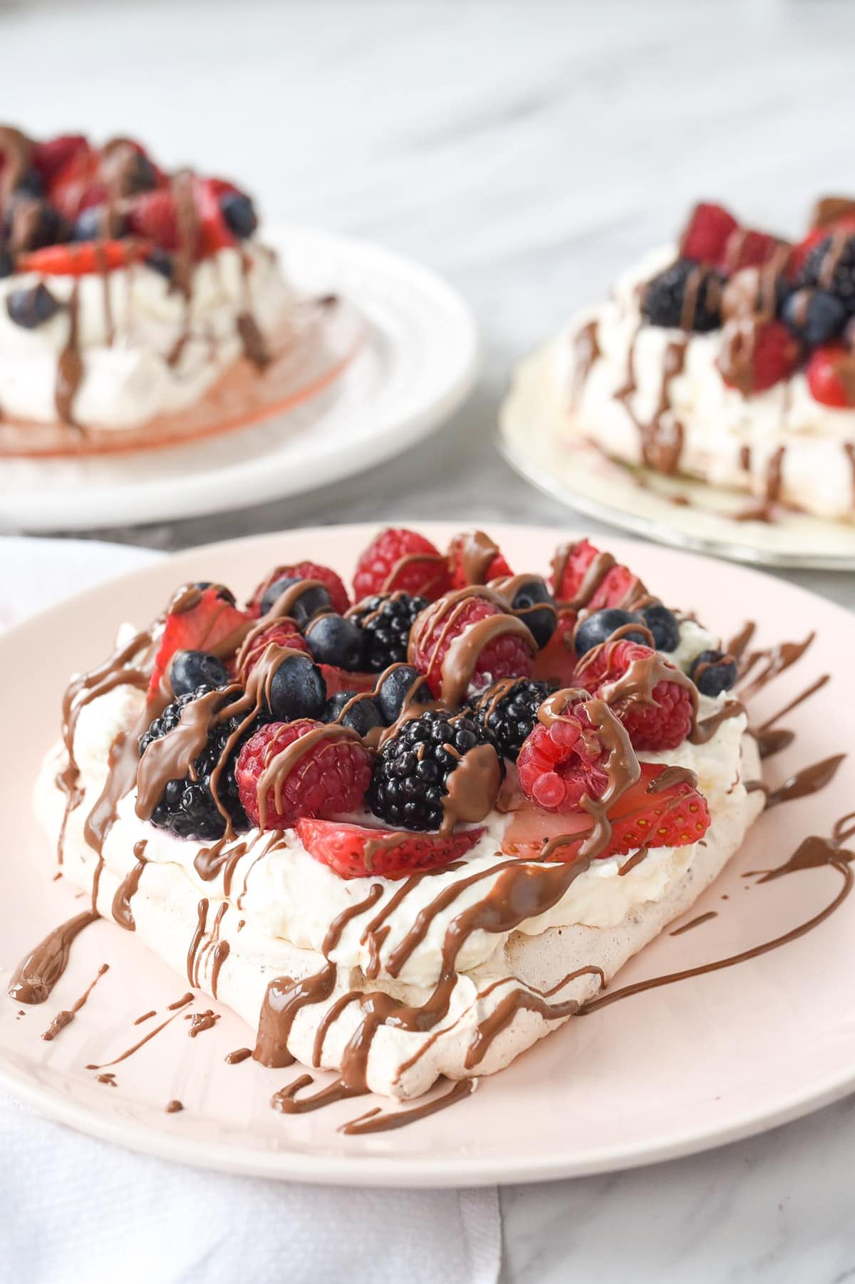 three heart shaped pavlovas on a plate