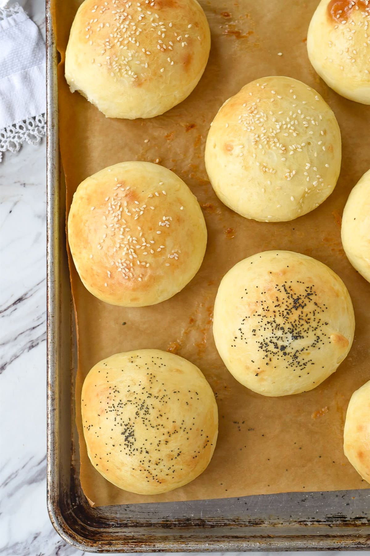 hamburger buns on a baking sheet