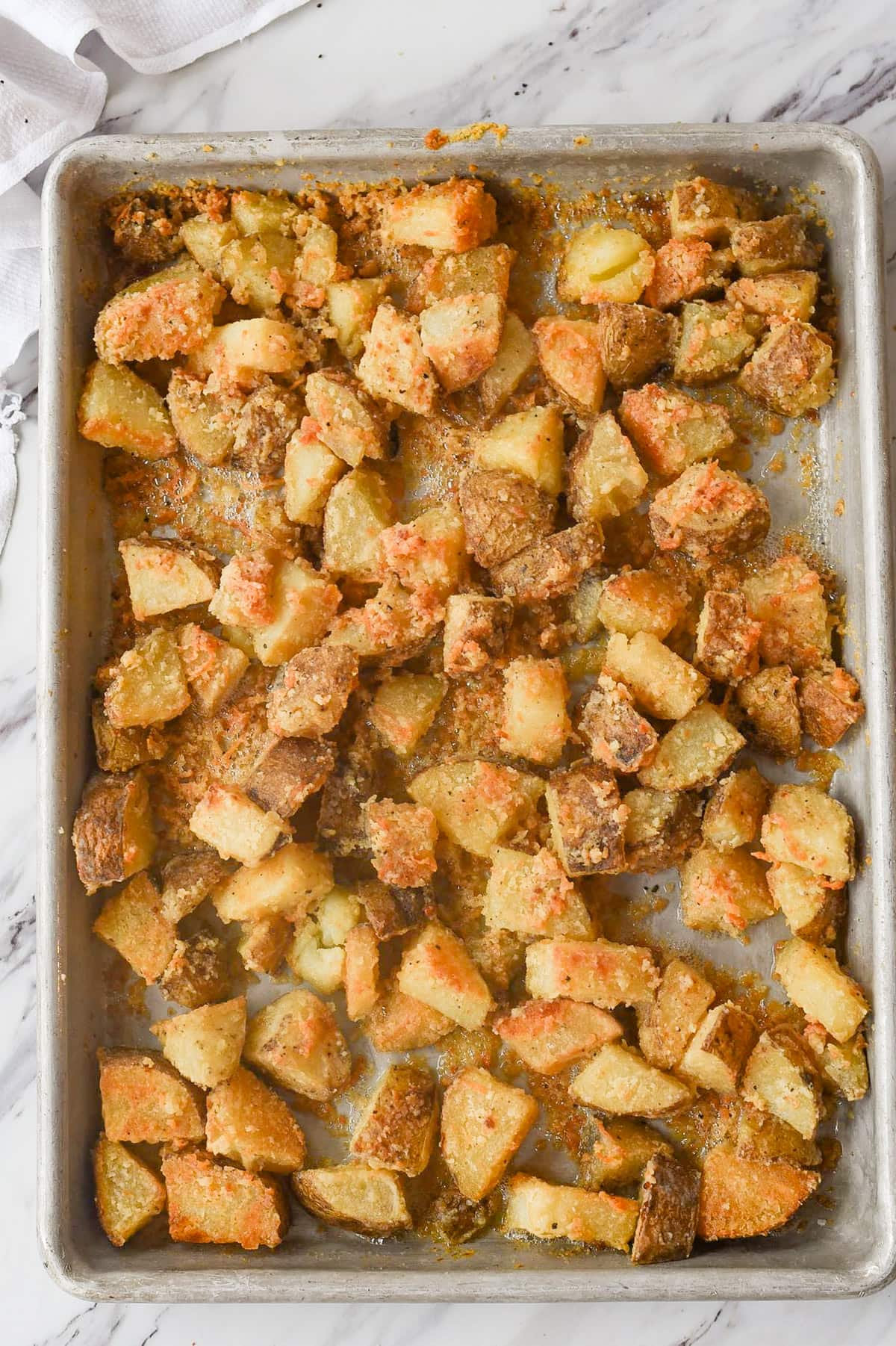 baked parmesan roasted potatoes on a baking sheet