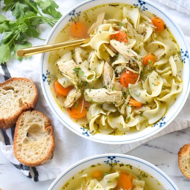 overhead shot of two bowls of instant pot chicken noodle soup