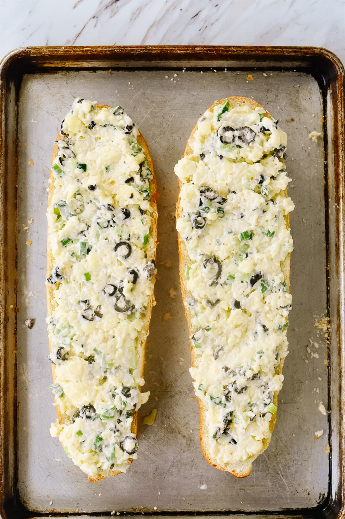 olive spread on bread ready for the oven