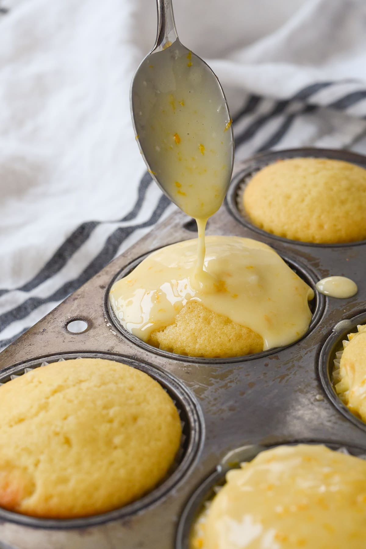 glazing an orange muffin