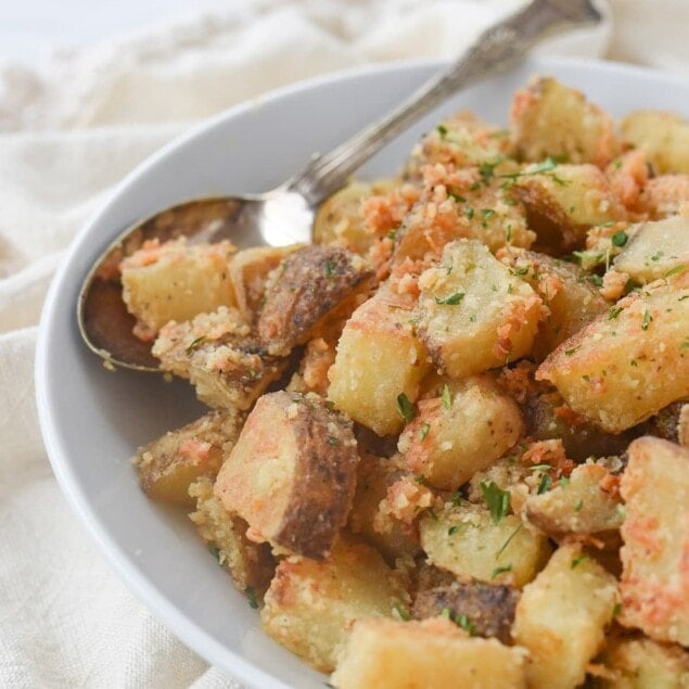 white bowl full of parmesan roasted potatoes