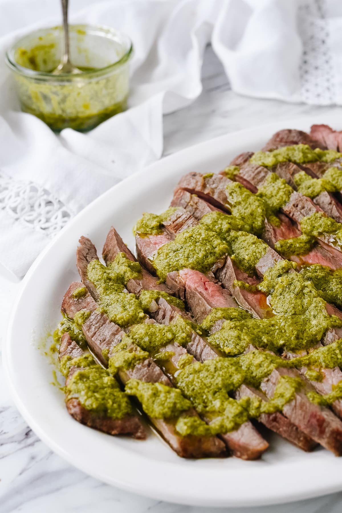 pesto drizzled over flank steak