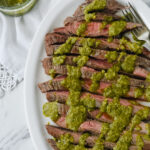 pesto flank steak on a white dish