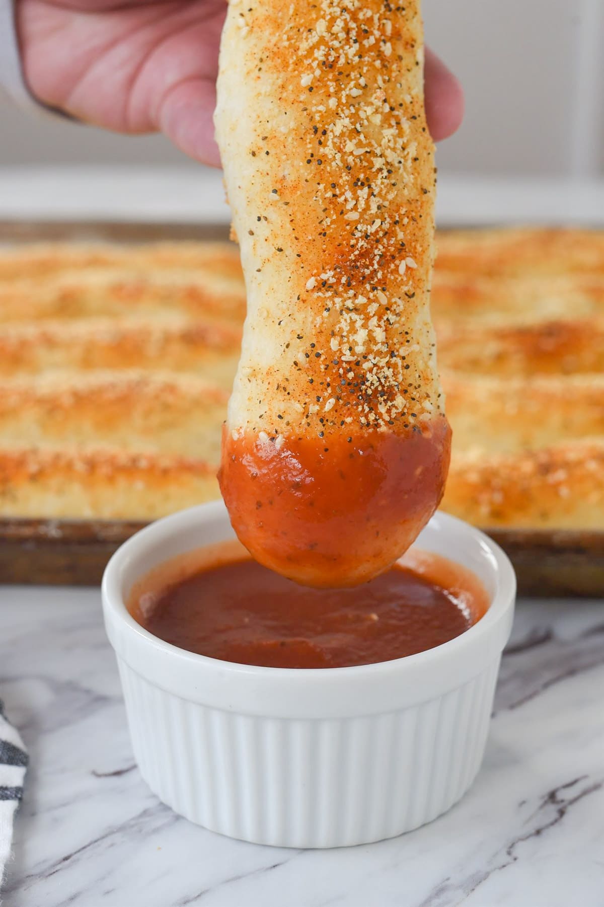 Dipping a breadstick in marinara sauce