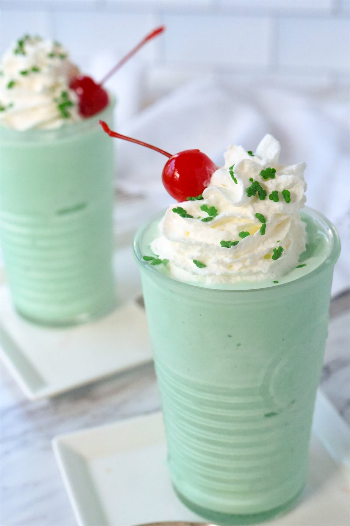 shamrock shake with shipped cream and cherry