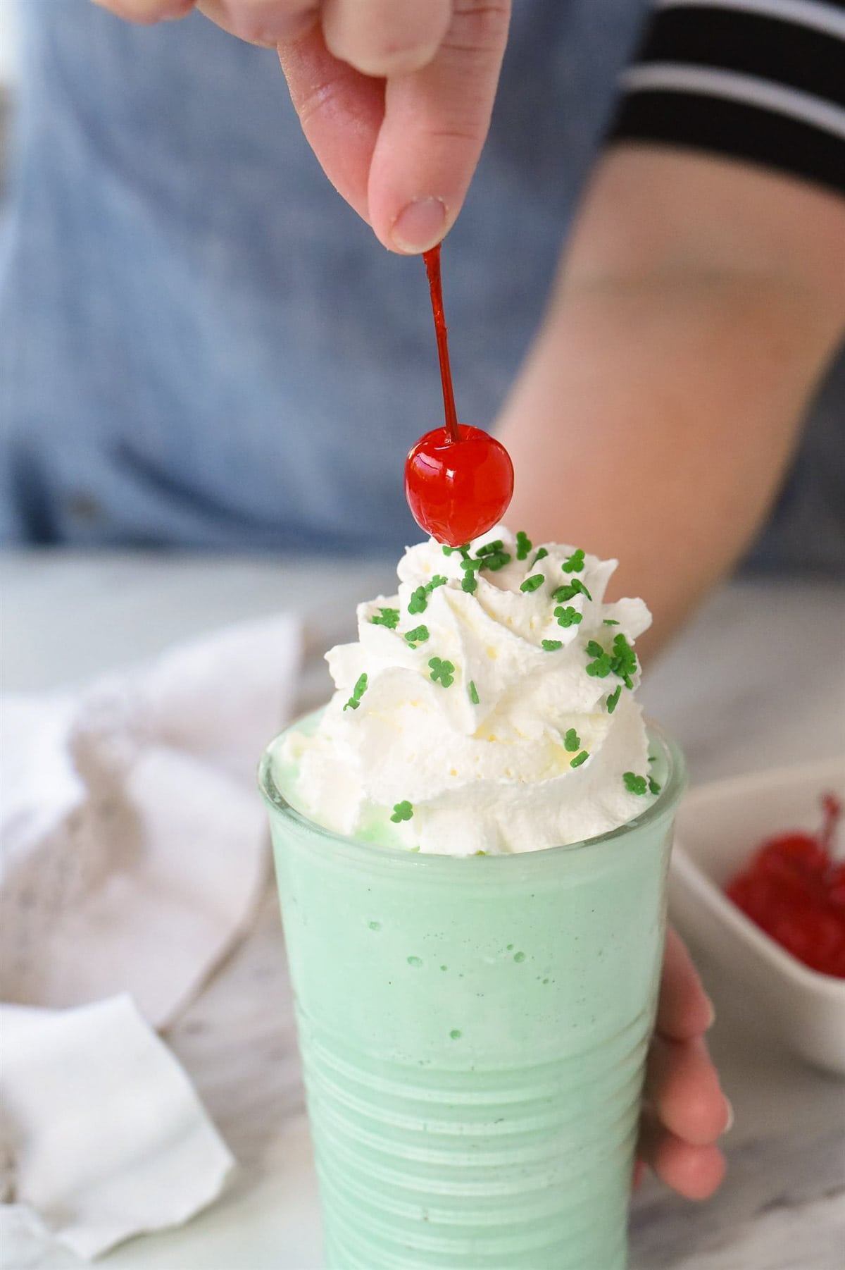 adding a cherry to a shamrock shake