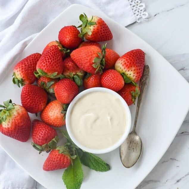 strawberries and brown sugar sour cream on a plate