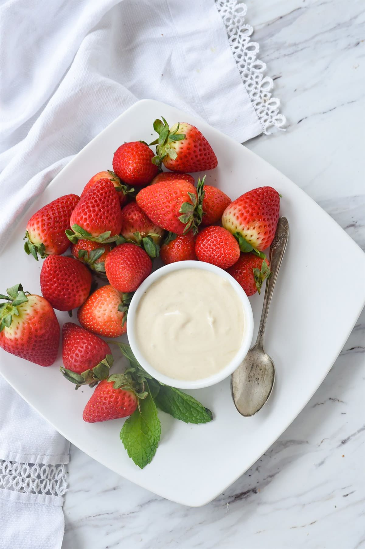 strawberries and brown sugar sour cream on a plate