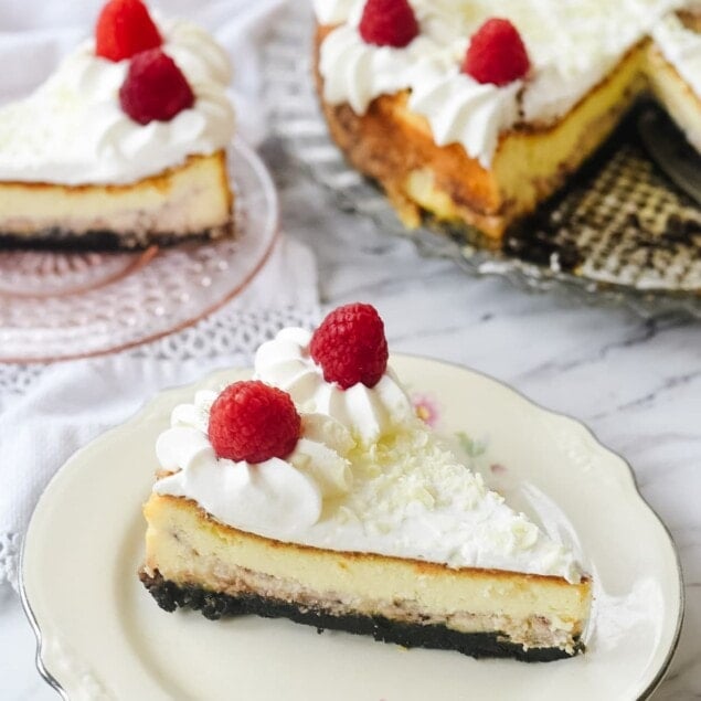 two slices of white chocolate raspberry cheesecake