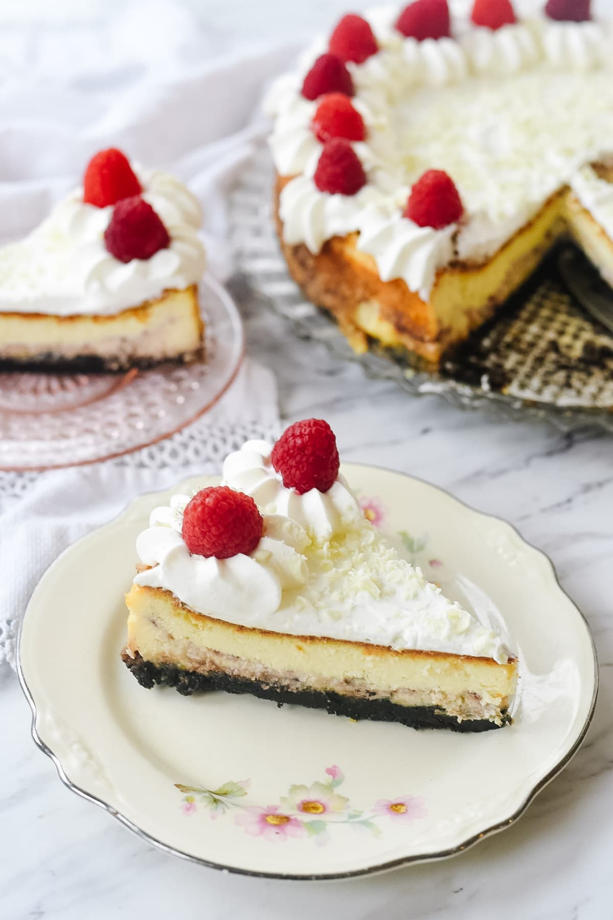 two slices of white chocolate raspberry cheesecake