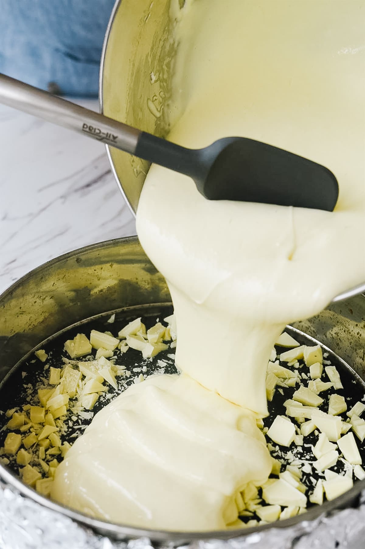 pouring cheesecake mixture into pan