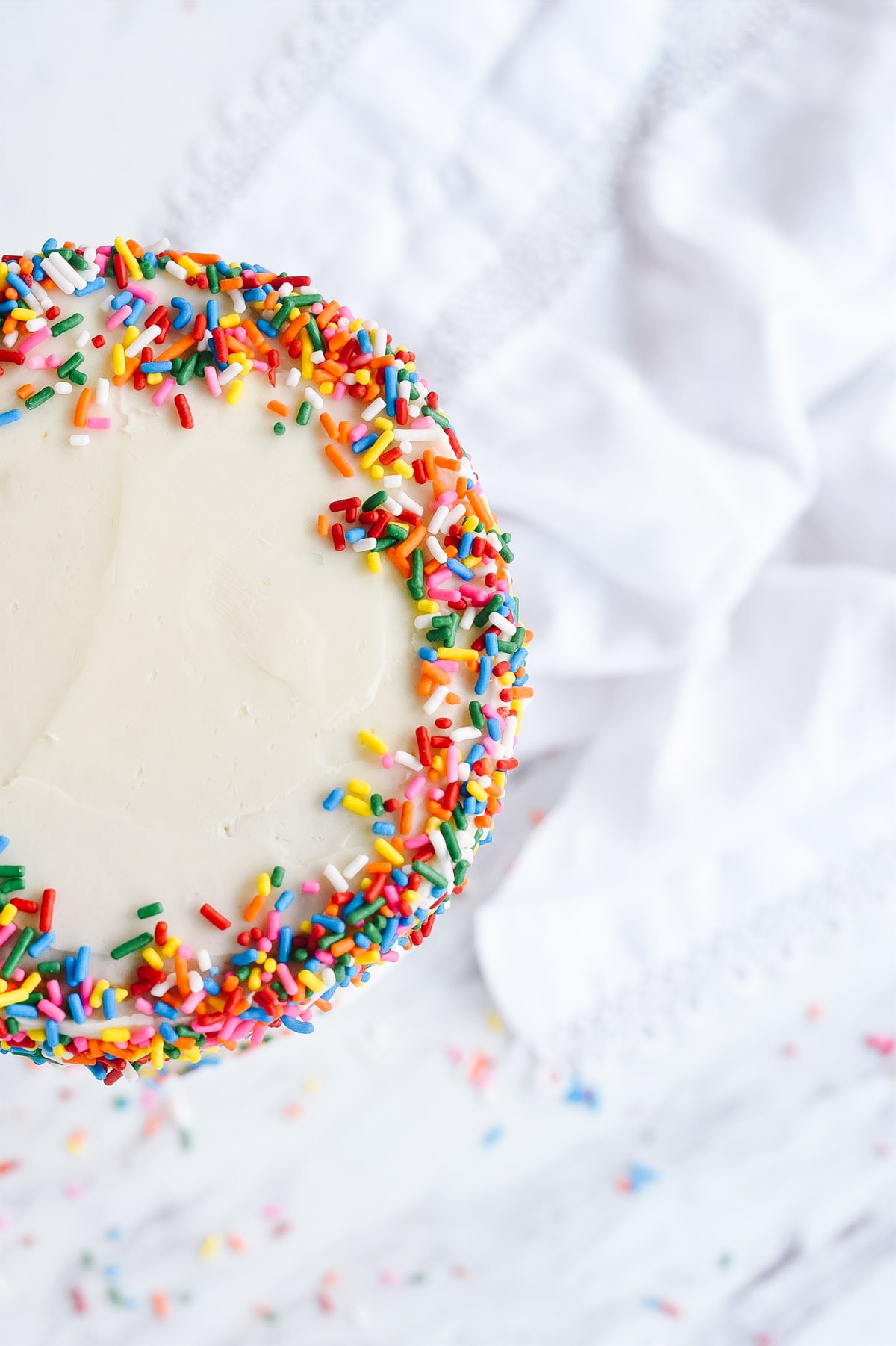 overhead view of a cake with sprinkles.