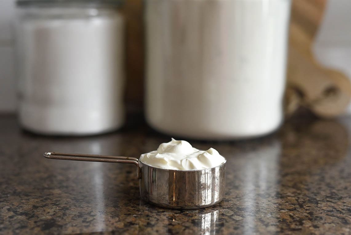 sour cream in a measuring cup