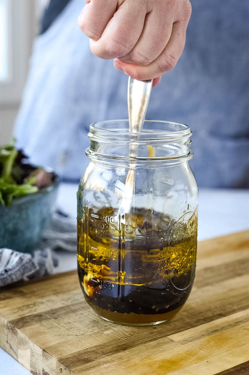 stirring vinaigrette in a jar