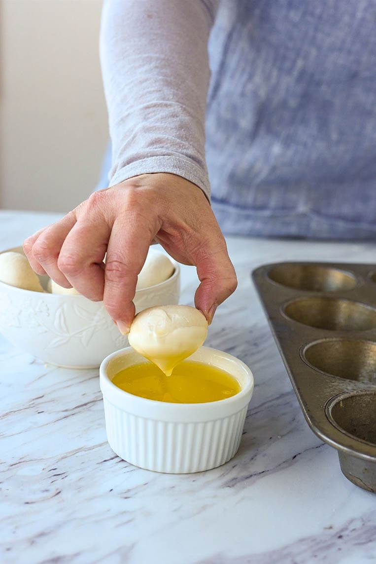 dipping frozen roll into butter