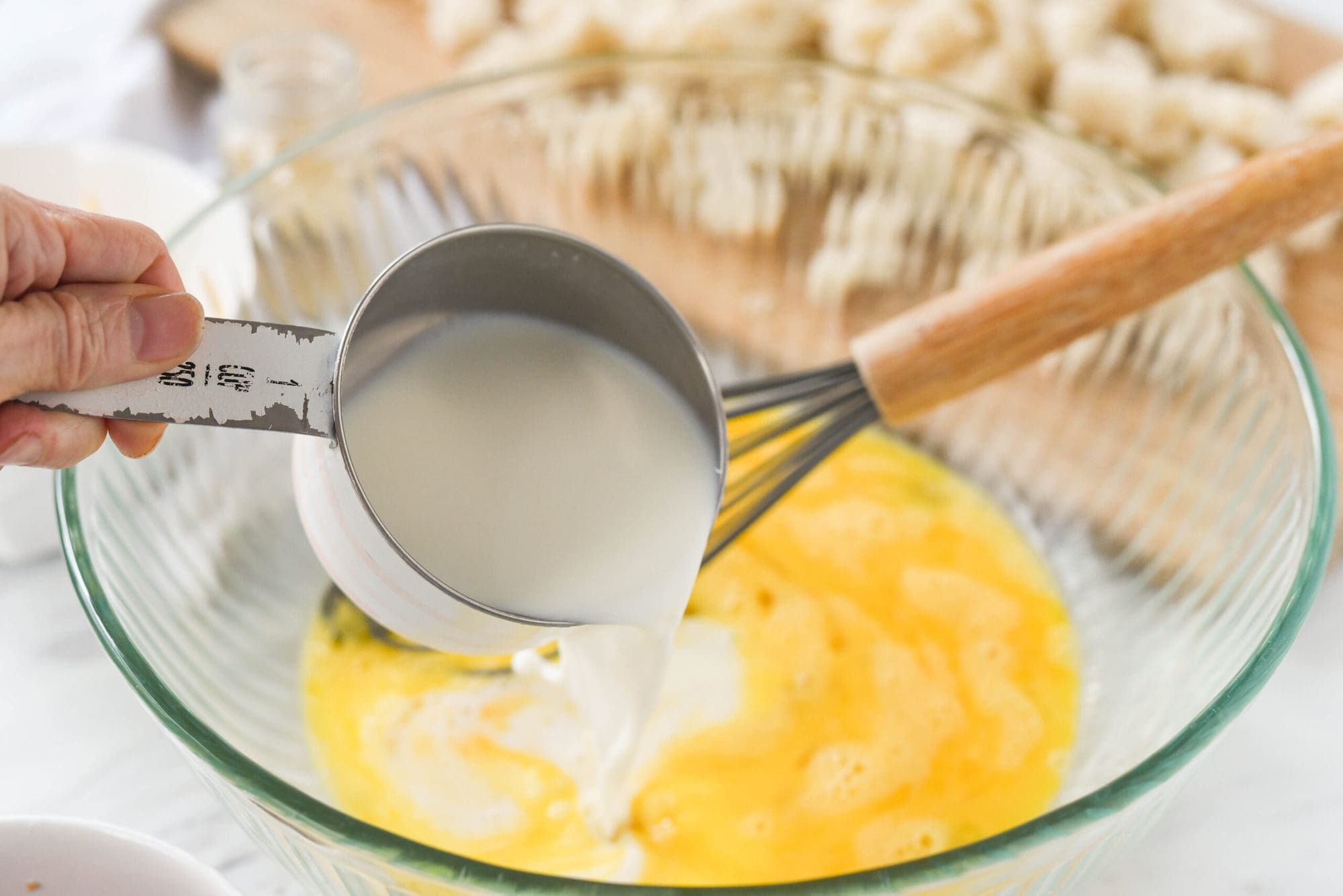 pouring milk into eggs