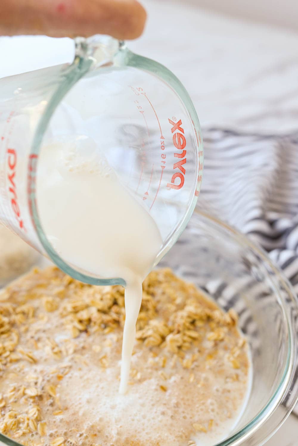 pouring milk into oatmeal