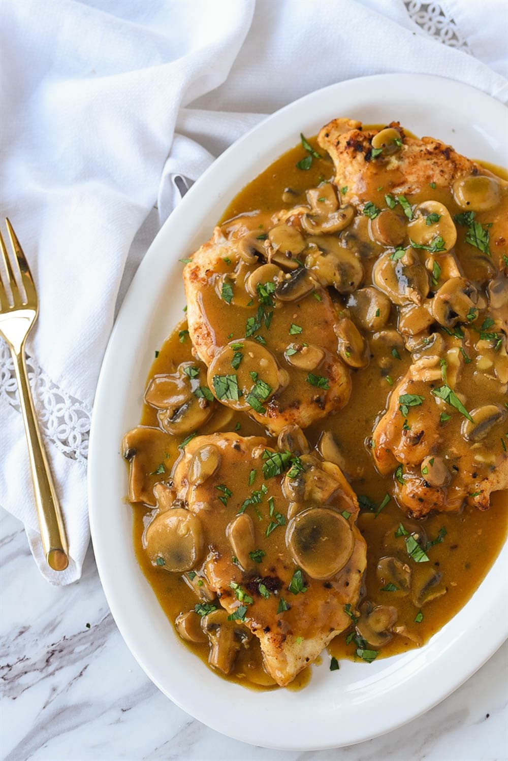 overhead shot of chicken and mushrooms on a platter