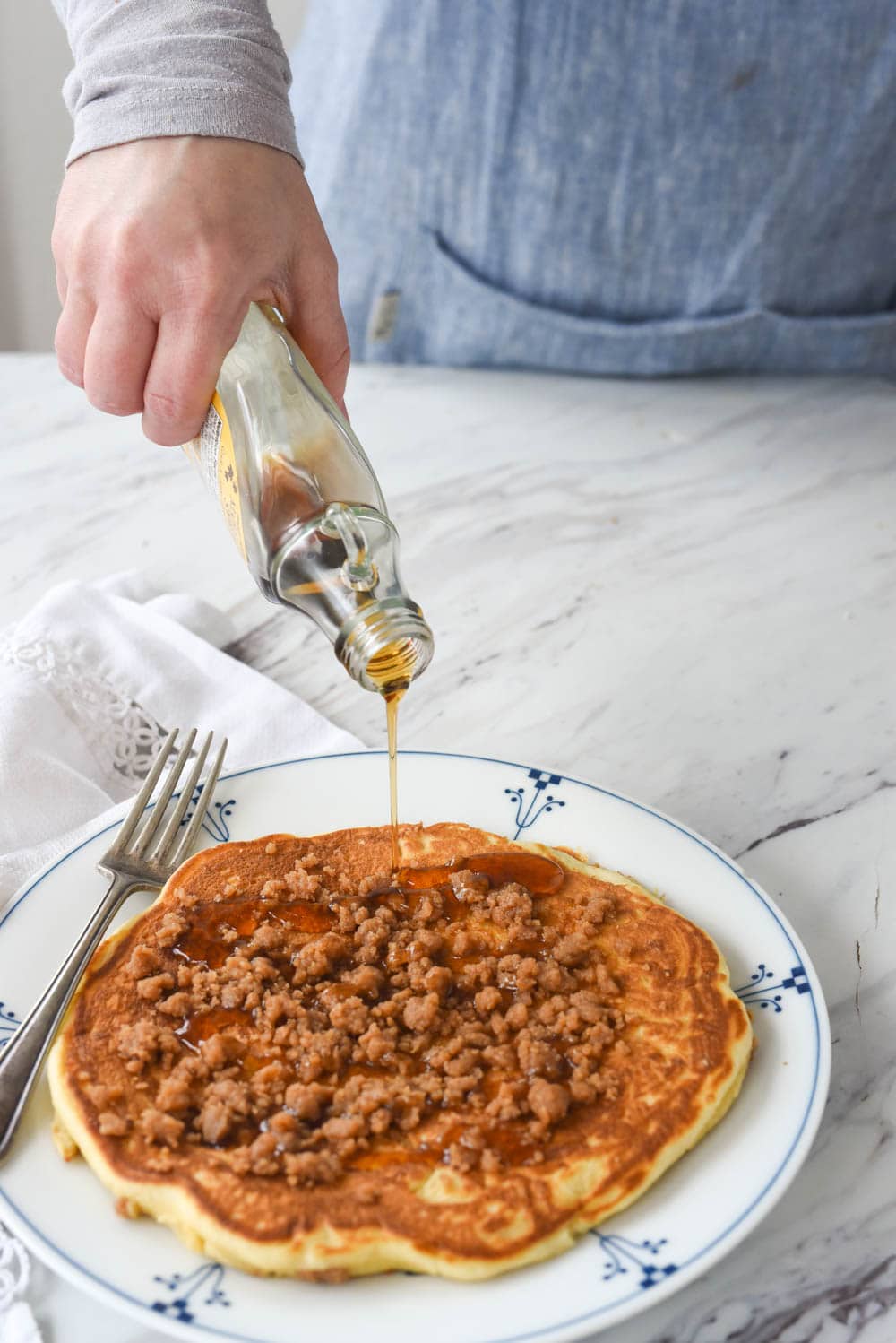 pouring syrup on streusel pancake