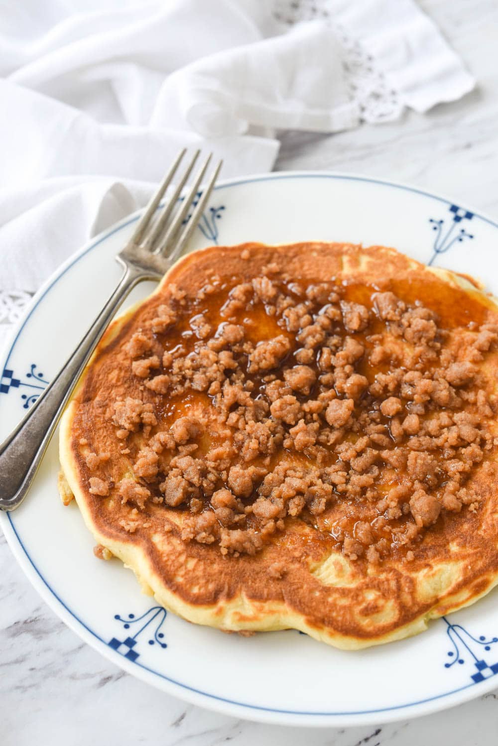 large cinnamon streusel pancake on a plate