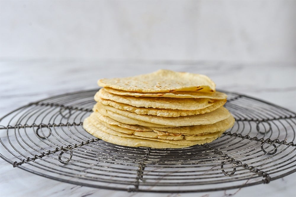 corn tortillas on a cooling rack