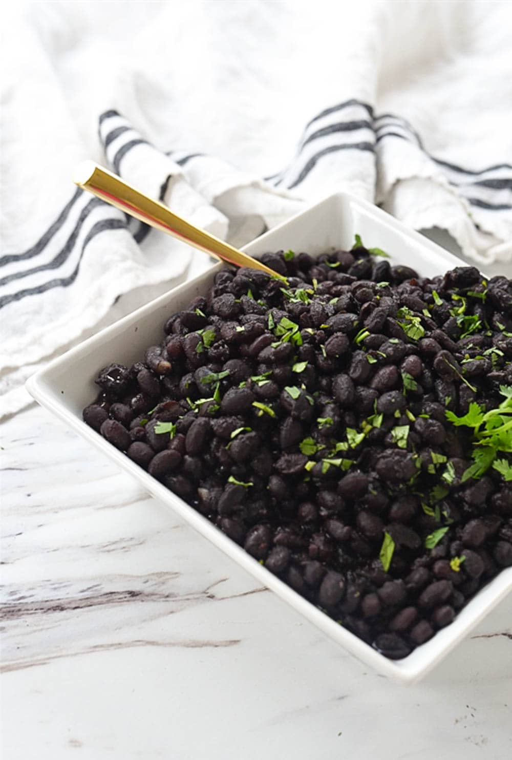 black beans in bowl with a spoon