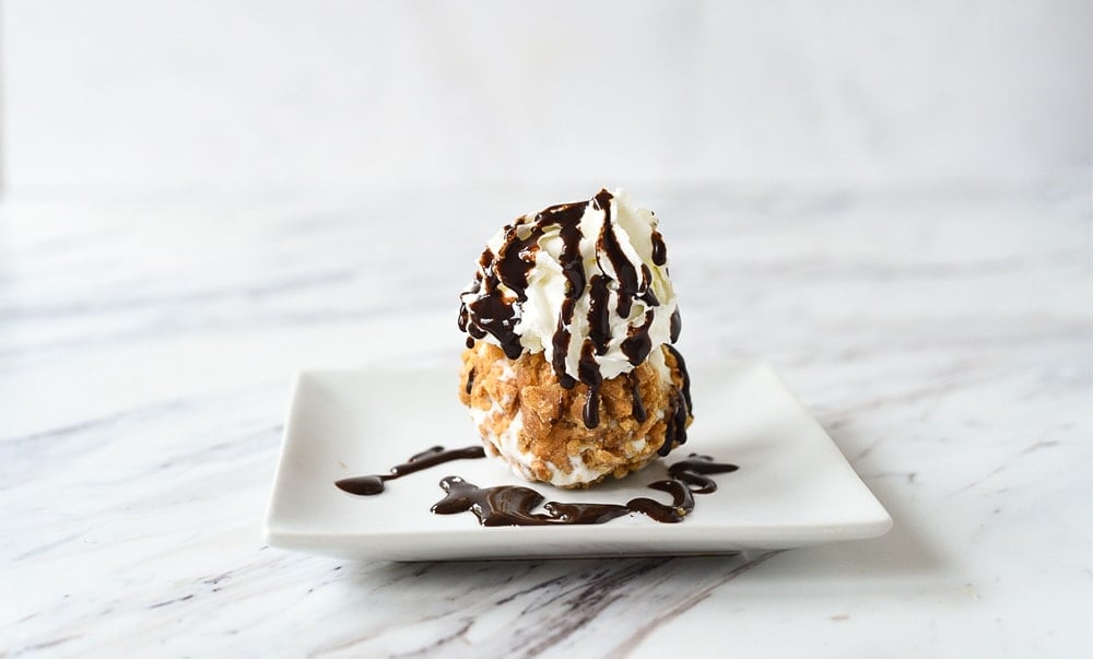 fried ice cream with whipped cream and chocolate syrup