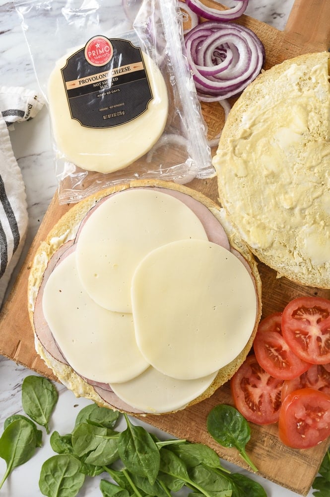 overhead shot of meat and cheese layered on a sandwich