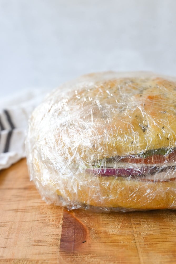 focaccia sandwich wrapped in plastic wrap