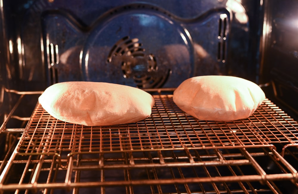puffed up pita bread in the oven