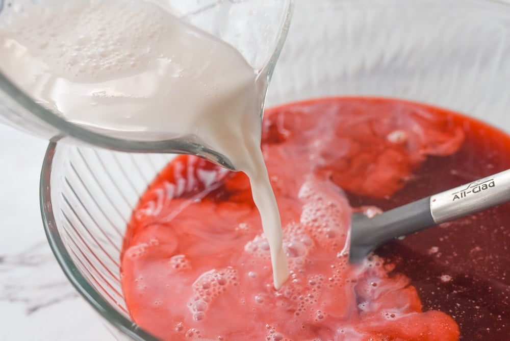 pouring milk into soda pop ice cream mixture