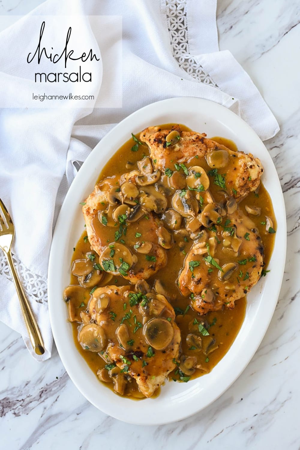overhead shot of chicken marsala on a plate