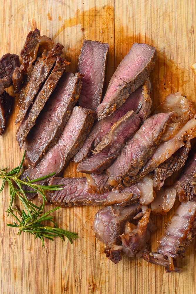 medium rare steak on a cutting board