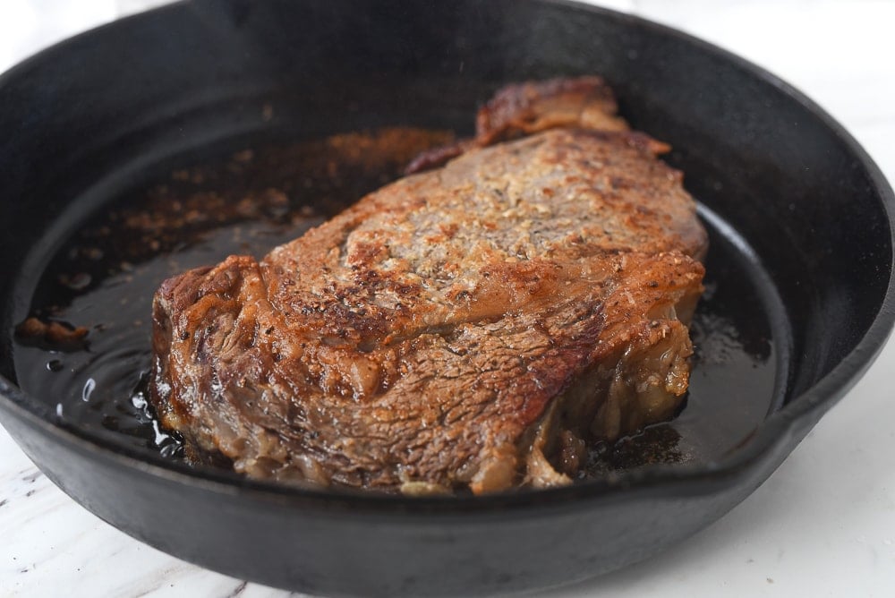 seared steak in cast iron pan