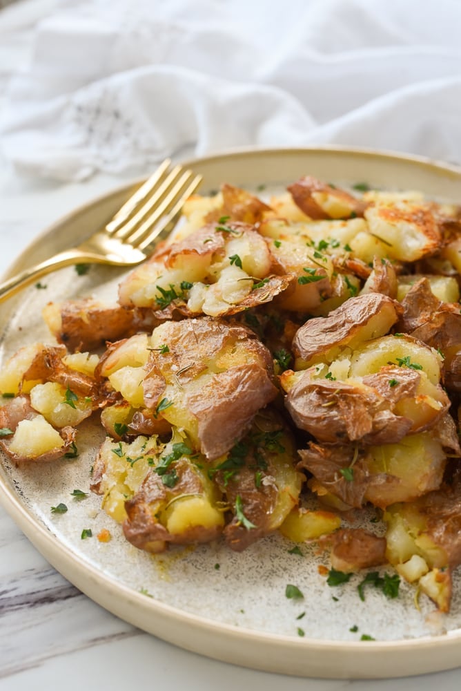 plate of smashed potatoes and a fork