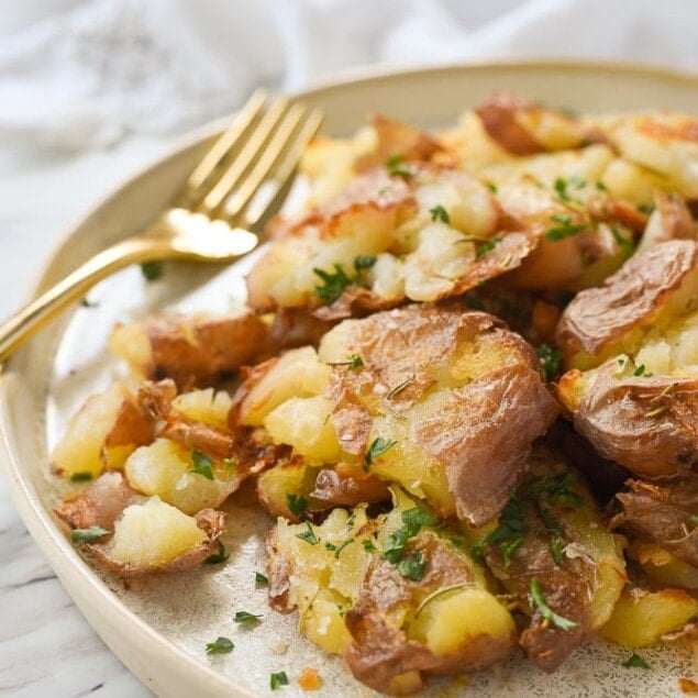 smash potatoes with a fork on a plate