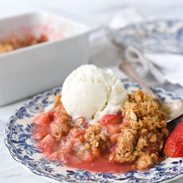plate of strawberry rhubarb crisp with ice cream
