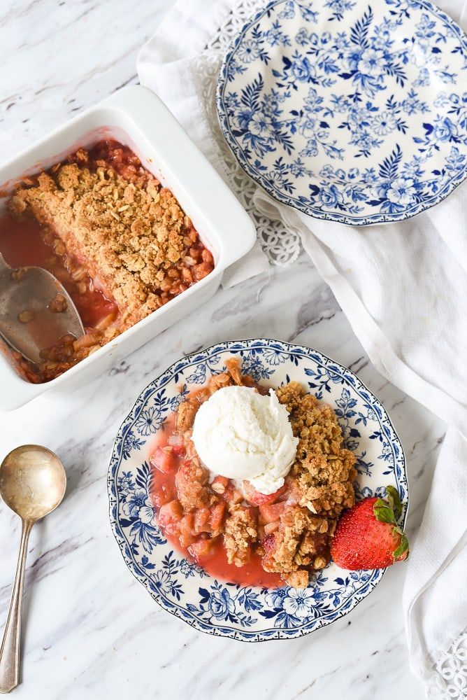 plate of strawberry rhubarb crisp with ice cream