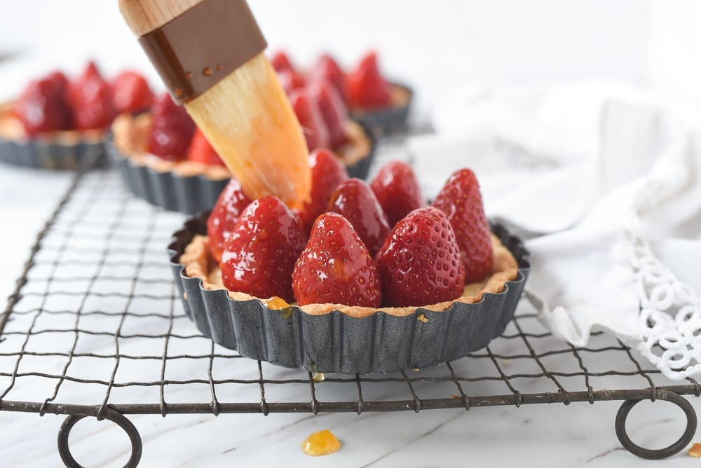 brushing glaze on strawberries