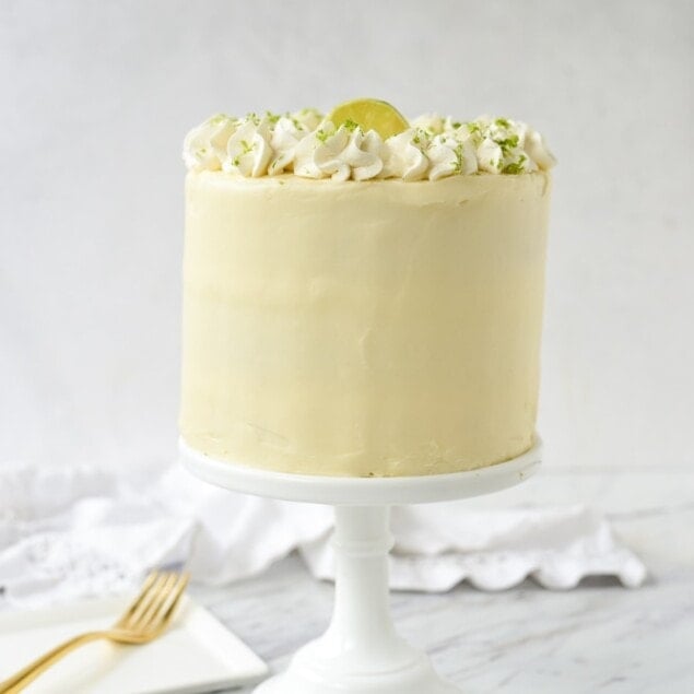 key lime cake on a white cake stand