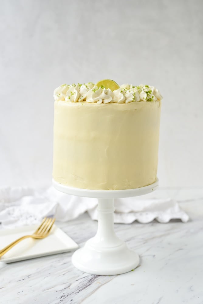 key lime cake on a white cake stand