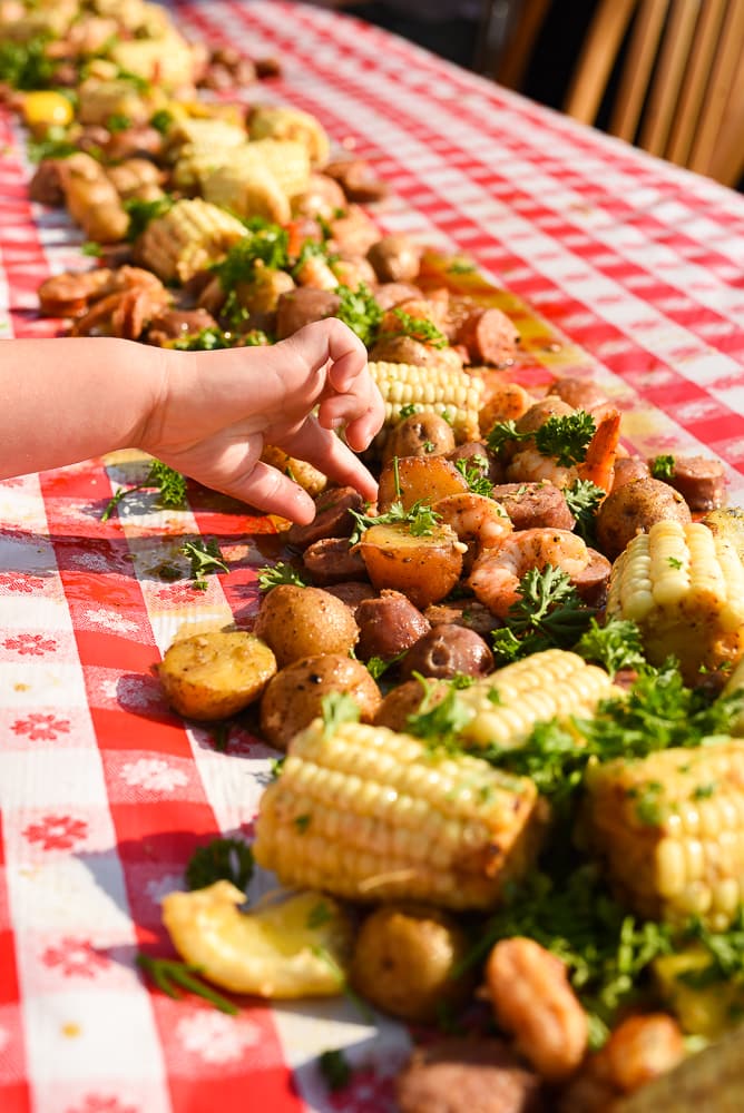 little hand reaching for low country boil