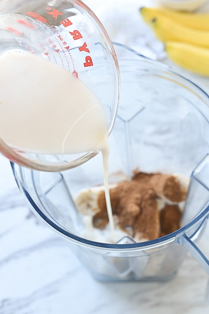 pouring milk into blender.