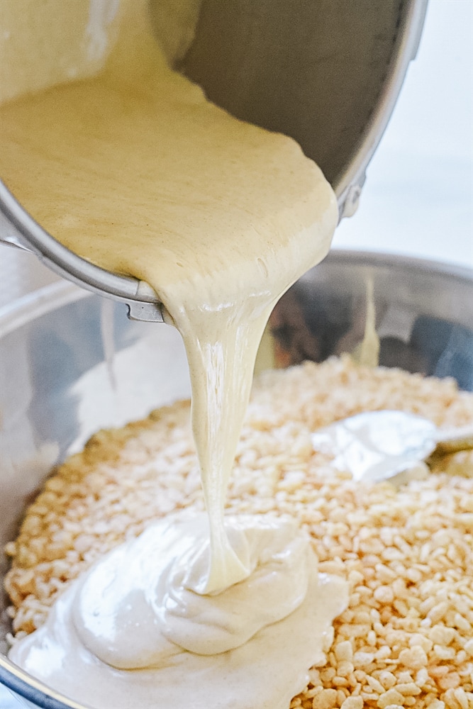 pouring marshmallow over rice krispies