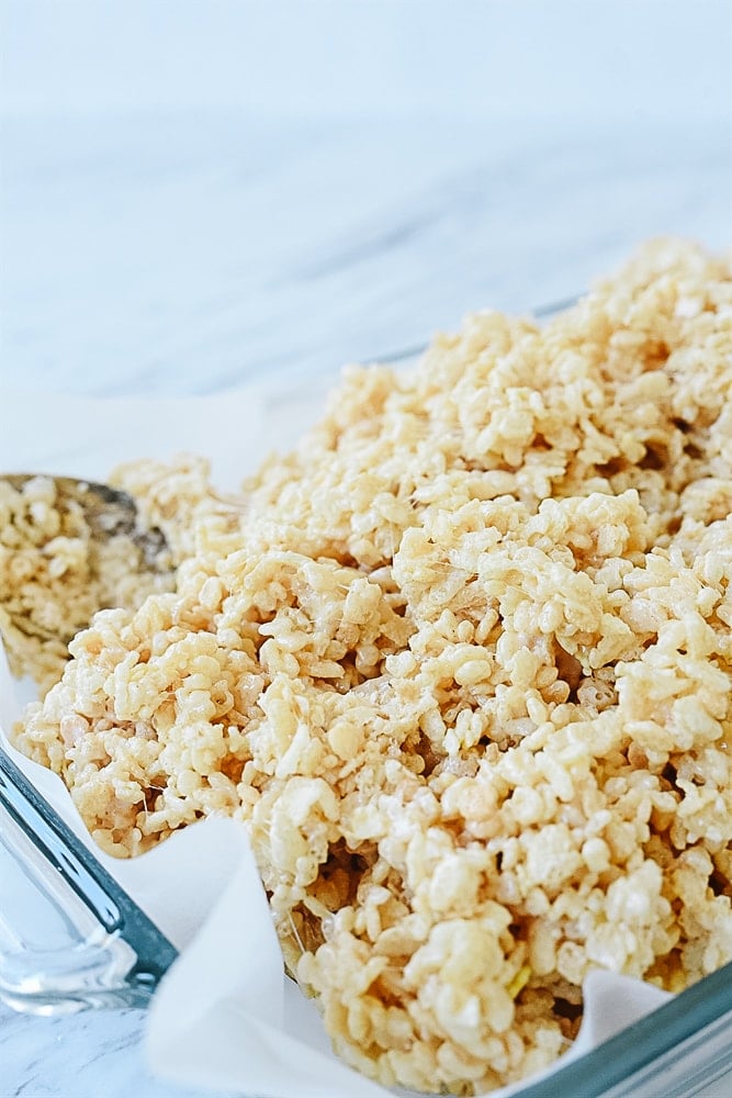 putting rice krispie treats is a pan.