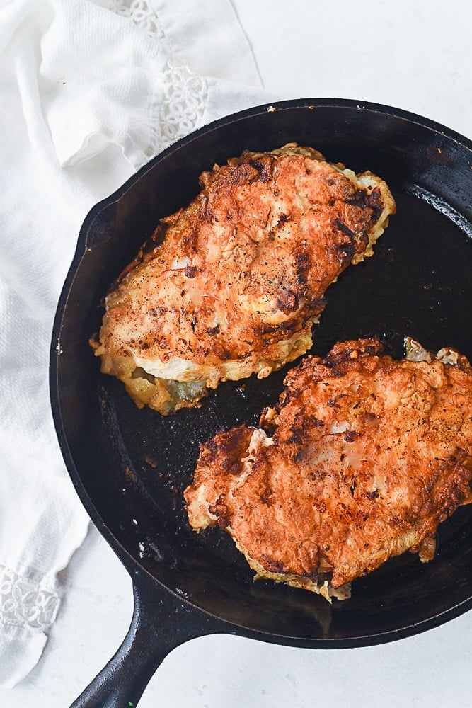 breaded chicken in frying pan