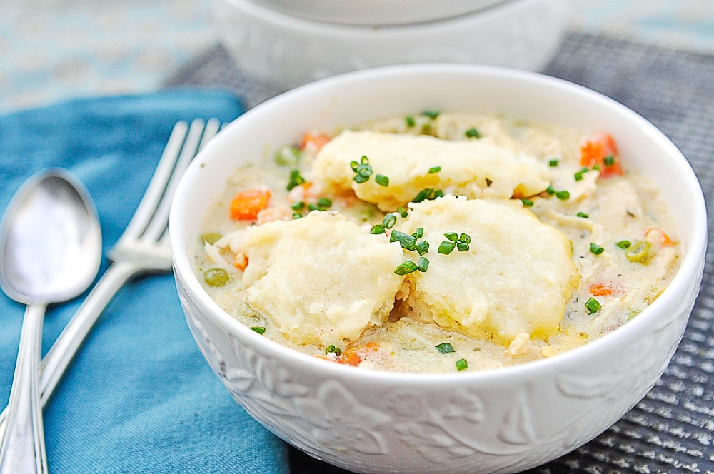 white bowl of chicken and dumplngs